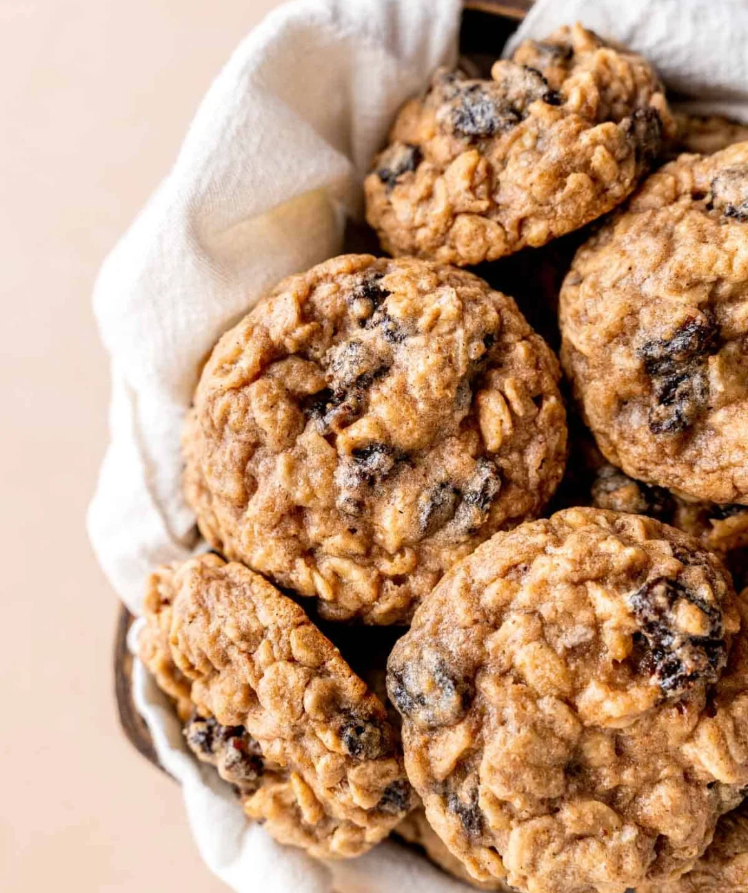 Freshly baked oatmeal raisin cookies on a cooling rack.